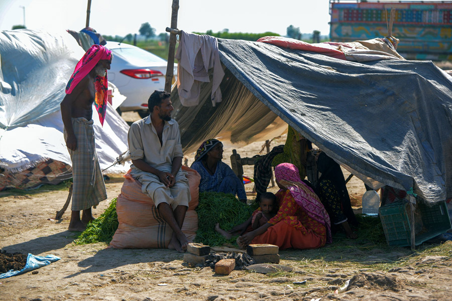 洪水に見舞われ、一時避難場所のテントに座るグラム・フセインさん家族（シンド州ダードゥ地区ケアプール・ネイサン・シャー／パキスタン） Credit: DEC