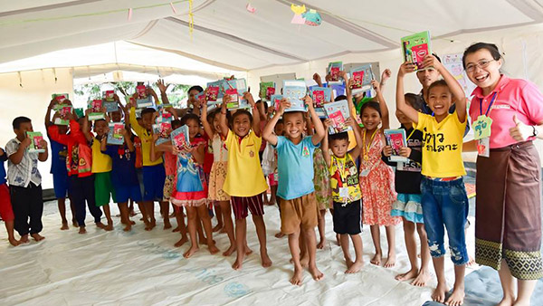Children receiving learning materials ©Plan International